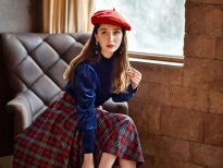 A girl sitting on a chair putting on heels